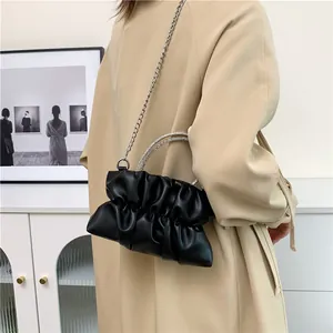 Fashionable black ruched cloud bag with sparkling rhinestone handles and chain strap