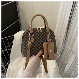 Classic shell-shaped satchel with vintage geometric pattern and golden hardware details