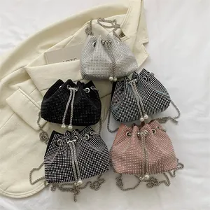 Detailed view of rhinestone bucket bags with pearl drawstrings and chain straps
