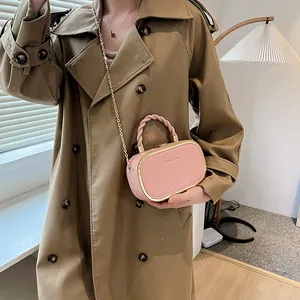 Pink faux leather box bag with gold metal frame and woven handle for women