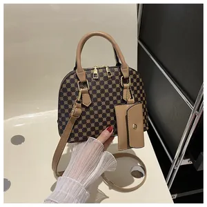 Close-up of retro shell bag with brown monogram pattern and detachable card holder pouch