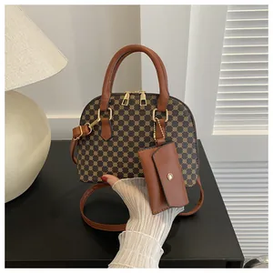 Detail of vintage dome handbag with geometric pattern, leather strap and mini coin purse