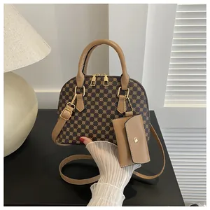 Detail of Boston bag with geometric pattern, top handles and small coin purse attachment