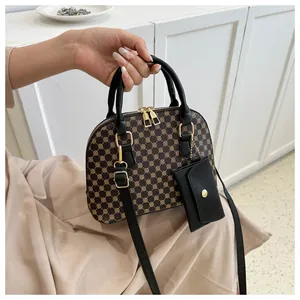 Detail of vintage shell bag with geometric pattern, leather straps and gold hardware