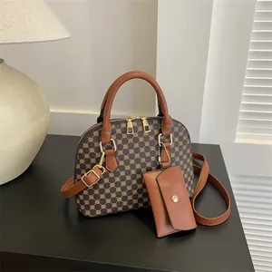 Retro Boston handbag with geometric pattern, top handle, and detachable strap on a desk