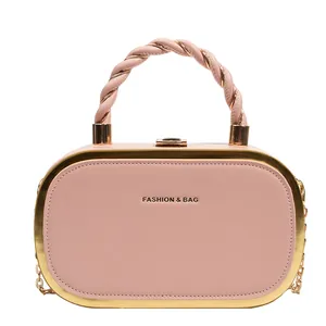 Elegant pink leather box bag with twisted handle and gold chain shoulder strap