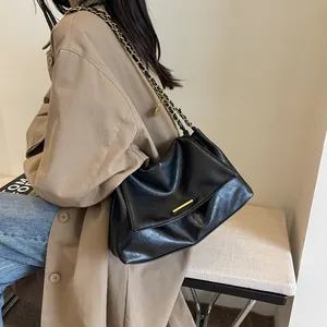 Minimalist black PU leather shoulder bag with gold chain strap and stylish flap closure