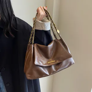 Chic dark brown faux leather shoulder bag with gold chain strap and metal buckle