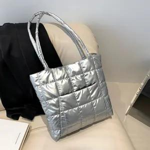 Silver quilted puffer tote bag with metallic finish and square embroidered stitching