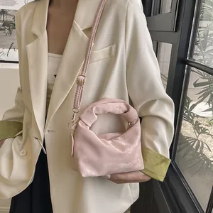 Elegant pale pink mini handbag with twisted handle and detachable strap for women