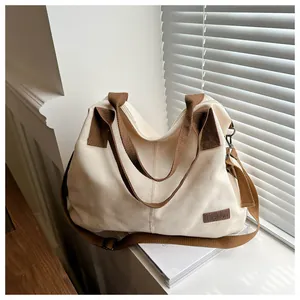 Detail of canvas tote bag with brown straps and 'Fashion' label on sunlit windowsill