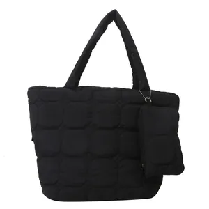 Black quilted tote bag set with matching small zipper pouch and puffy shoulder straps