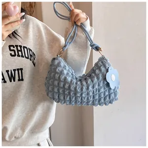 Detail of light blue puffy lattice shoulder bag featuring a soft 3D textured fabric