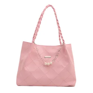 Pink quilted tote bag for women with woven shoulder straps and pearl chain accent
