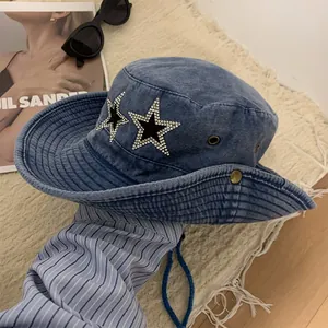 Detail of blue denim sun hat with sparkling rhinestone star patches and windproof rope