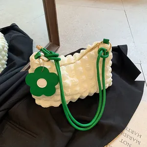 Minimalist white bubble texture shoulder bag with vibrant green straps and flower charm