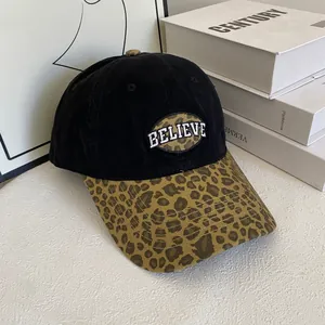 Detailed close-up of a leopard print brim baseball cap with white Believe embroidery