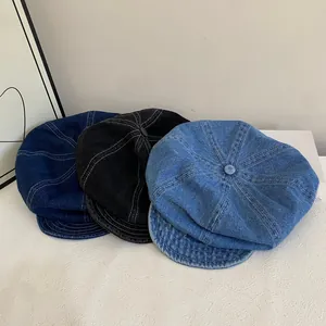 Three-pack denim newsboy caps in dark blue, black, and light blue on white display