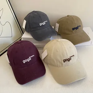 Close-up of embroidered letters on multi-color washed cotton baseball caps for women