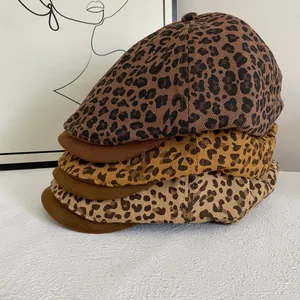Three leopard print berets with leather brims in brown, khaki, and apricot colors