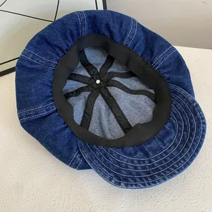 Detail view of denim newsboy cap interior featuring sweatband and reinforced structure