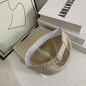 Detail view of cotton baseball cap interior showing metal buckle and white sweatband