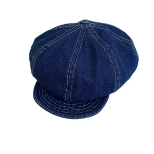 Retro dark blue denim newsboy cap for men and women featuring contrast white stitching details
