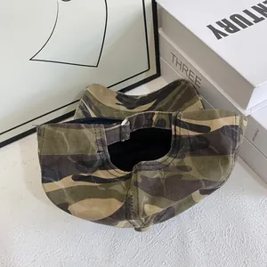 Detail view of the camouflage baseball cap showing the adjustable silver metal buckle strap