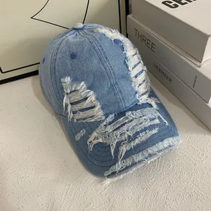 Distressed light blue denim baseball cap with vintage washed finish and ripped detailing