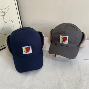 Winter navy blue fleece baseball cap with warm ear flaps and cartoon strawberry patch