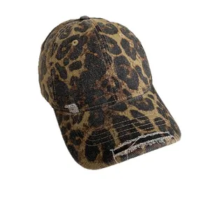 Distressed leopard print baseball cap with vintage pink accents and a worn-out denim finish