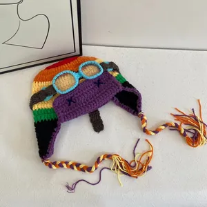 Knitted aviator beanie with colorful crochet patterns and decorative goggles