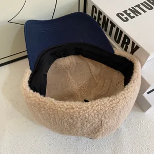 Detail of warm navy blue and beige fleece baseball cap with soft inner lining and textures