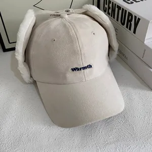 Detail view of winter baseball cap with plush ear flaps and Warmth embroidery