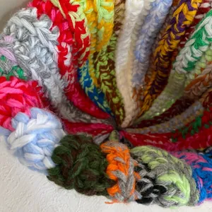 Detailed view of colorful striped knit texture and ribbed weave pattern of the beanie