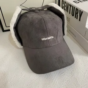 Detail of gray suede winter baseball cap with plush earflaps and Warmth embroidery