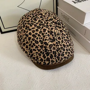 Macro shot of leopard print newsboy cap with corduroy texture and suede brim detail