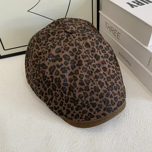 Detail shot of vintage leopard print newsboy cap with dark brown brim and soft texture