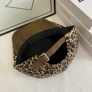 Detail view of leopard print baseball cap featuring metal buckle and suede texture