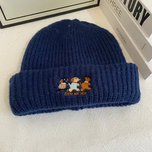 Close-up of cute dog embroidery and JOIN MY JOY slogan on navy ribbed knit beanie