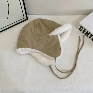Close-up of khaki aviator hat with warm white faux fur lining and functional earflaps