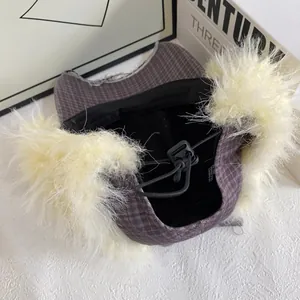 Detail of checkered trapper hat with faux fur lining and adjustable elastic drawstring