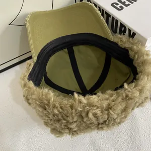 Detail view of the plush lamb wool brim and canvas lining of the warm baseball cap
