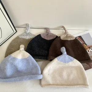 Chic color-block knitted beanies with top knot detail in soft Morandi tones for women