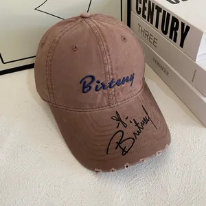 Retro khaki baseball cap with blue Birteny embroidery and distressed brim details