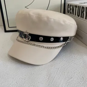 Cream PU leather newsboy cap with black decorative strap and silver anchor pendant