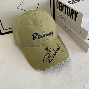 Distressed khaki baseball cap with Birteny embroidery and vintage worn brim detailing