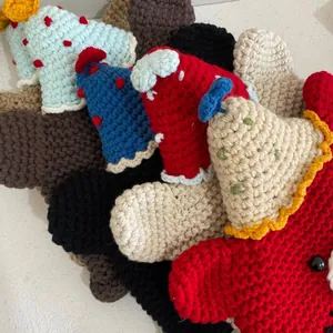 Detailed view of hand-knitted mini beanies in various colors and crochet textures