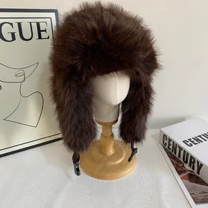 Detail of dark brown faux mink fur aviator hat with thick plush texture and buckle strap
