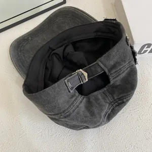 Detail of vintage charcoal grey washed cotton cap showing the adjustable metal buckle strap